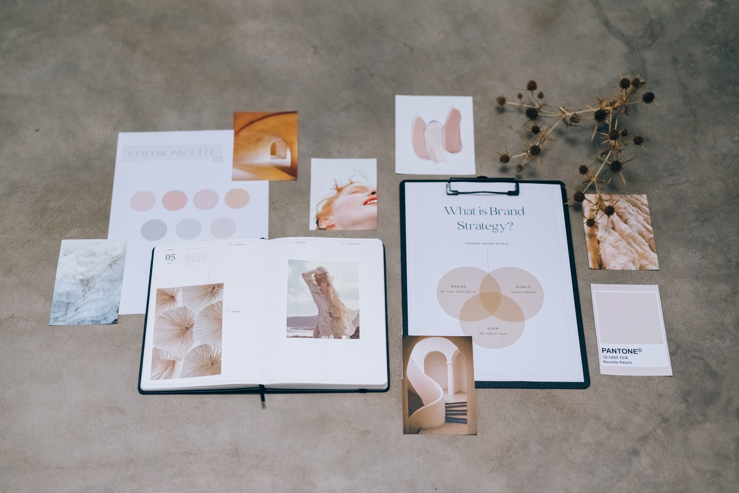 Brand identity flat lay with color palettes and logo planning documents